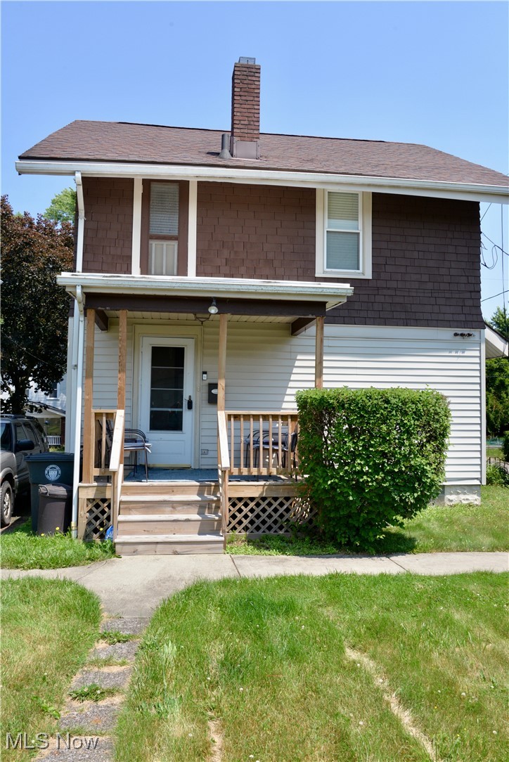 904 Chalker Street Akron, OH 44310 - Photo 27 of 28 View of front of house featuring covered porch, a chimney, and a front yard