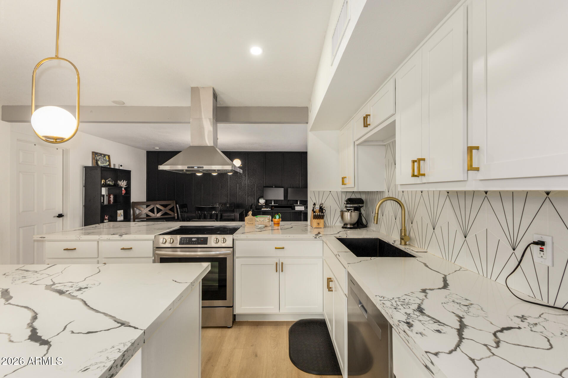 a kitchen with a stove a sink and a refrigerator