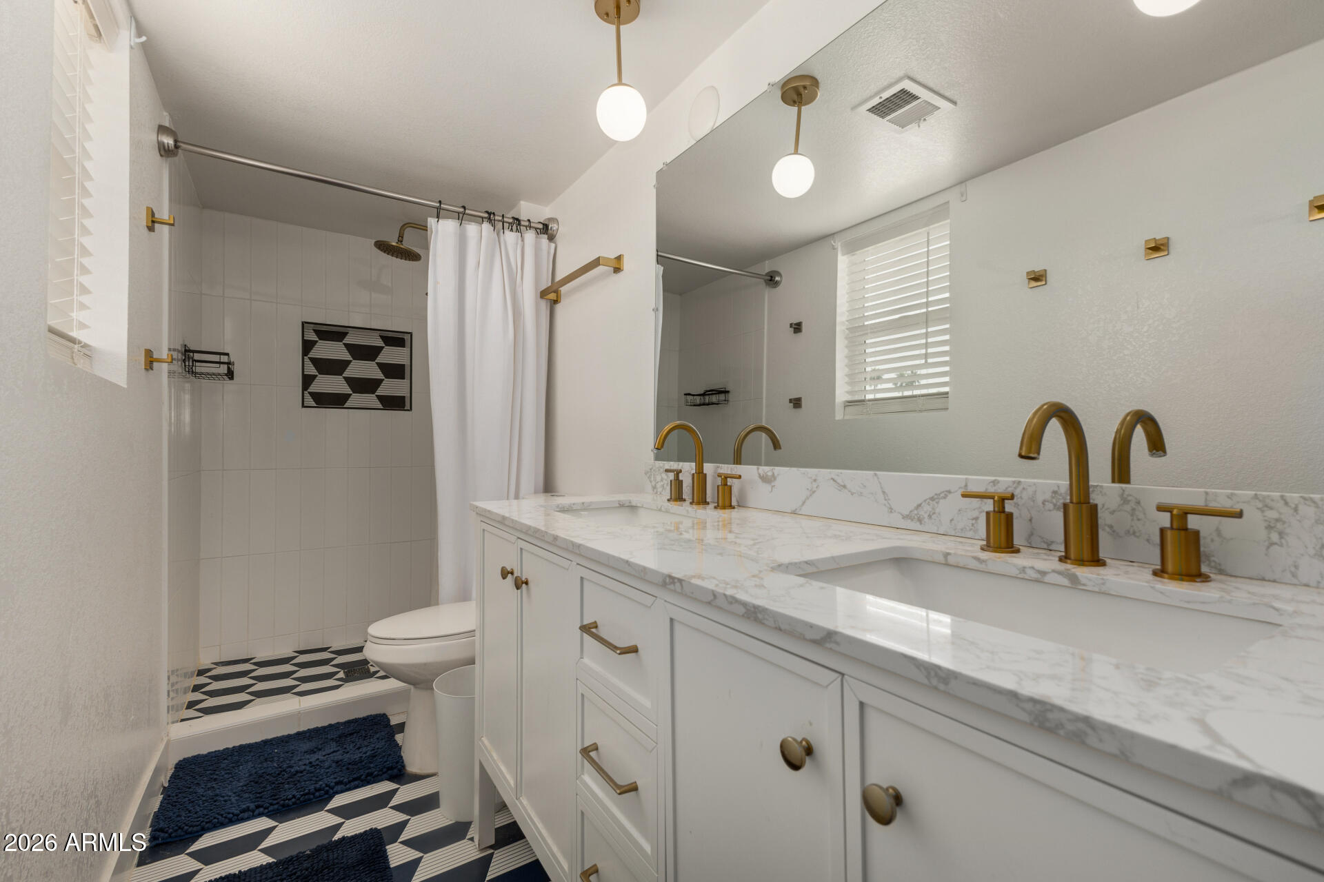 1560 North Freeman Mesa, AZ 85201 - Photo 13 of 22 a bathroom with a sink a toilet and a mirror