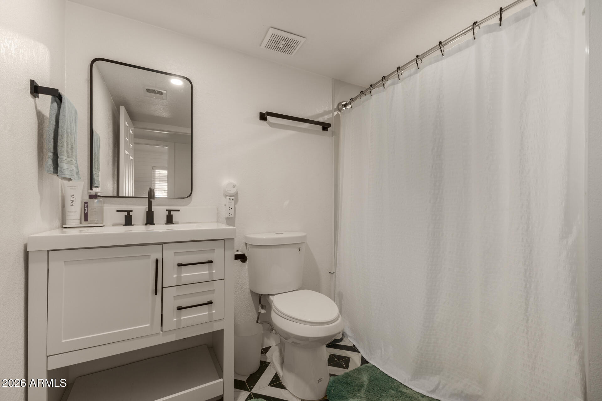 1560 North Freeman Mesa, AZ 85201 - Photo 16 of 22 a bathroom with a toilet a sink and a mirror