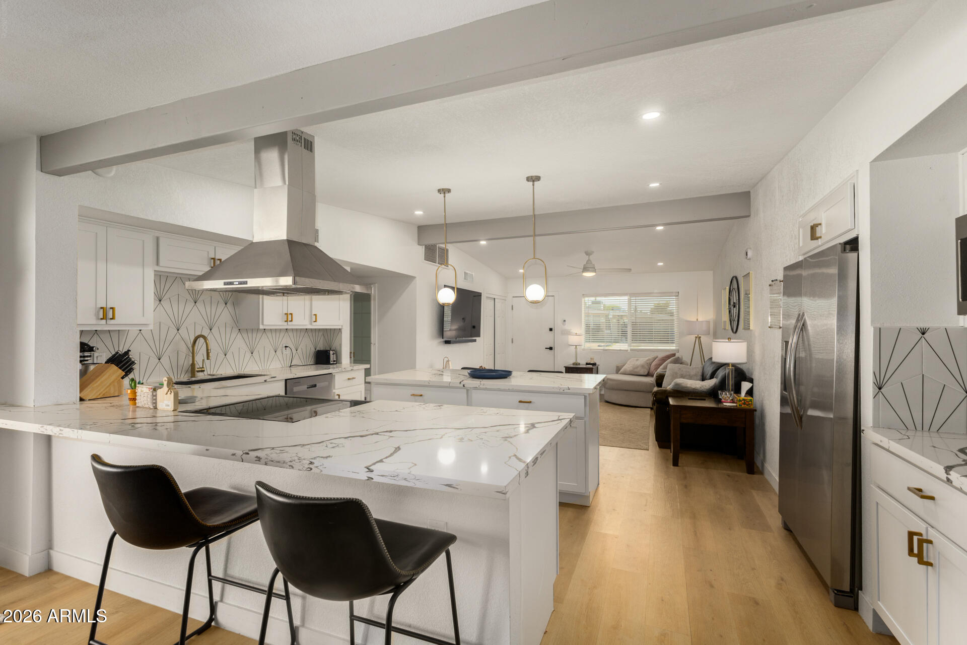1560 North Freeman Mesa, AZ 85201 - Photo 3 of 22 a large kitchen with a counter space a sink appliances and living room view