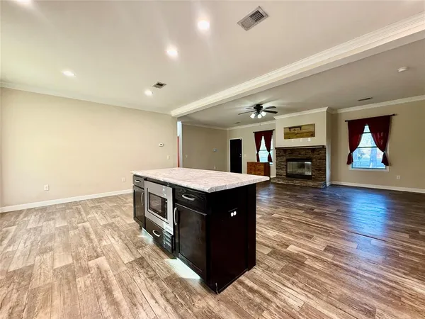 a kitchen with stainless steel appliances granite countertop a stove and a wooden floors