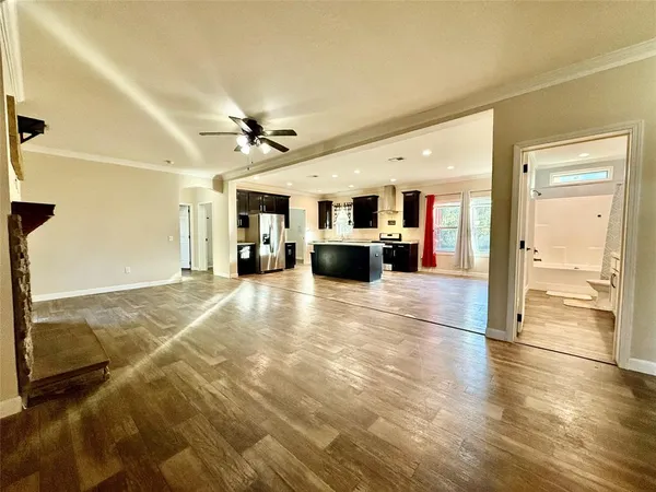 a view of a livingroom with furniture a ceiling fan and window