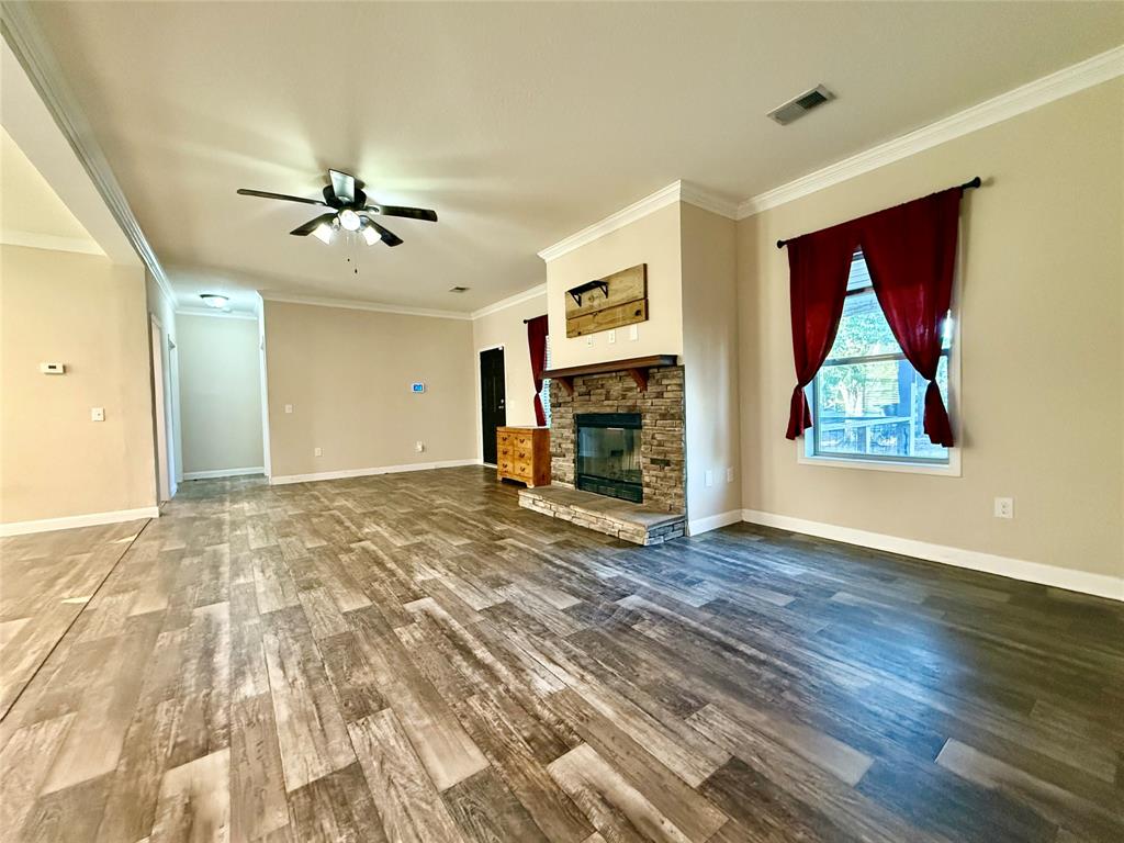 159 Yellow Pine Road Sibley, LA 71073 - Photo 14 of 33 a view of empty room with wooden floor and fan