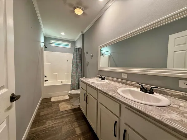 a bathroom with a granite countertop sink a large mirror and a bathtub