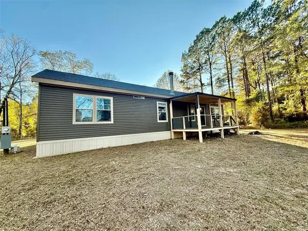 a view of a house with a yard and garage