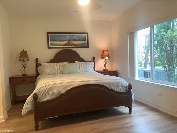 a bedroom with a bed and window