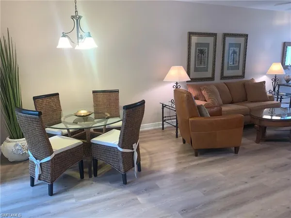 a workspace with furniture and a chandelier
