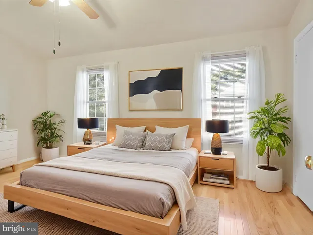a bedroom with bed and a potted plant