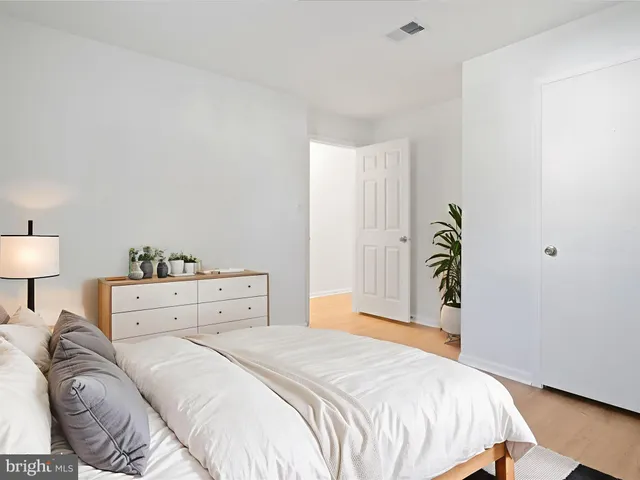 a bedroom with a bed and a lamp