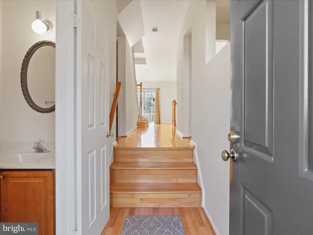 a view of a hallway with wooden floor and entryway