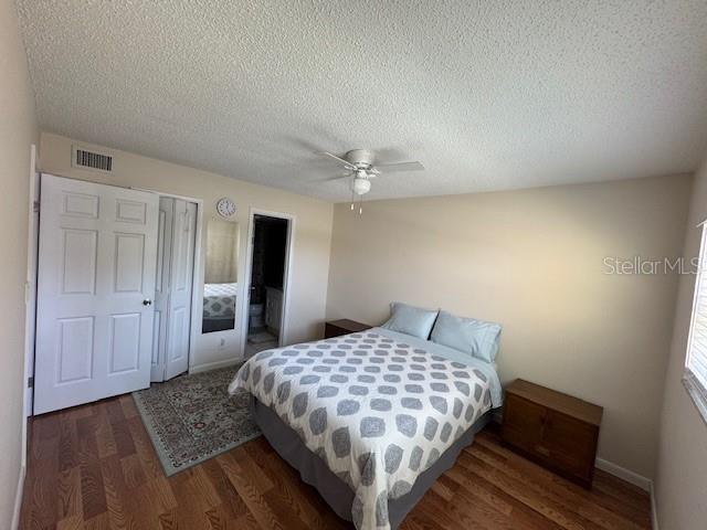 11485 Oakhurst Road, Unit 319 Largo, FL 33774 - Photo 6 of 63 a bedroom with a large bed and a chandelier