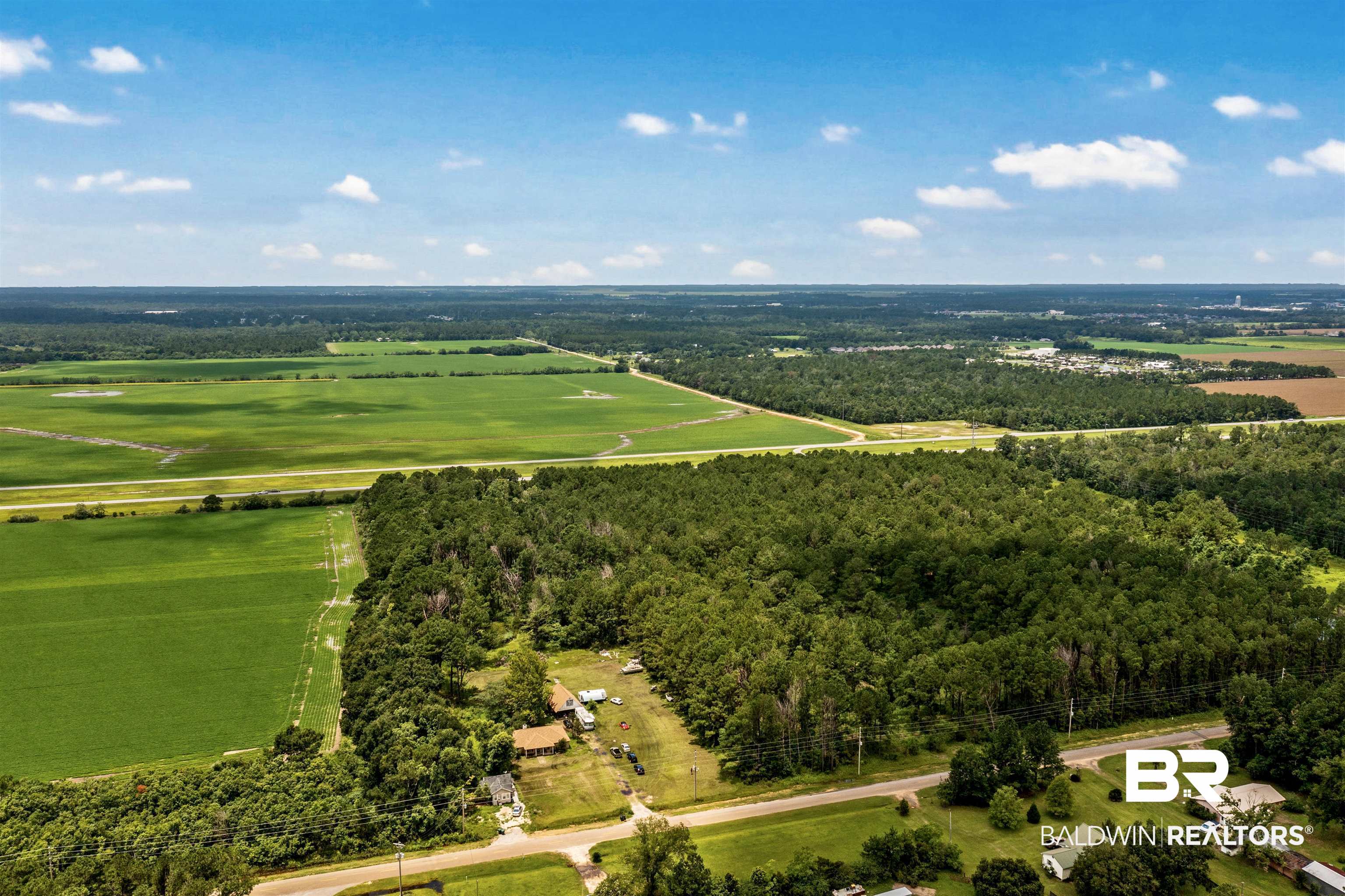 7767 Roscoe Road Gulf Shores, AL 36542 - Photo 1 of 1 View of rural area featuring a heavily wooded area