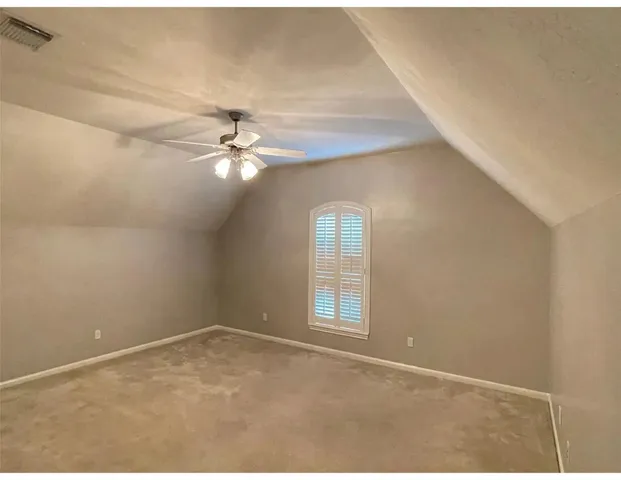 a view of a room with window and ceiling fan