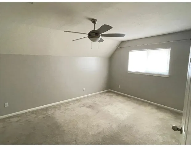 a view of an empty room and a window