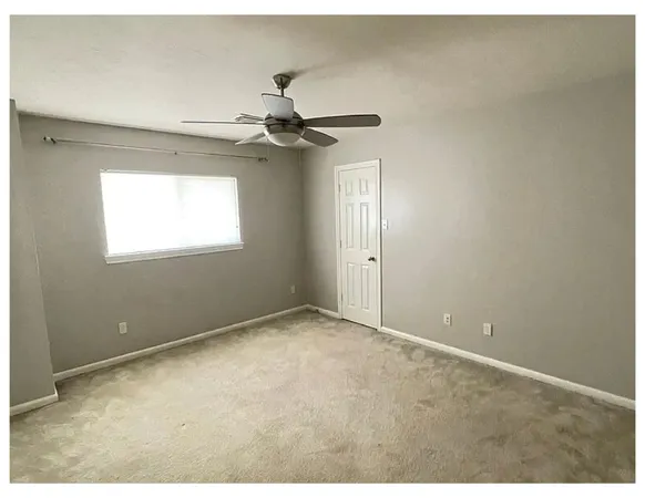 a bathroom with a granite countertop sink a mirror a bathtub and shower