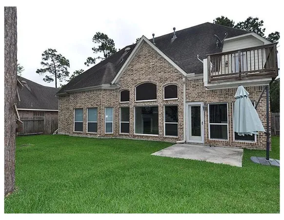 a house with a yard and wooden fence