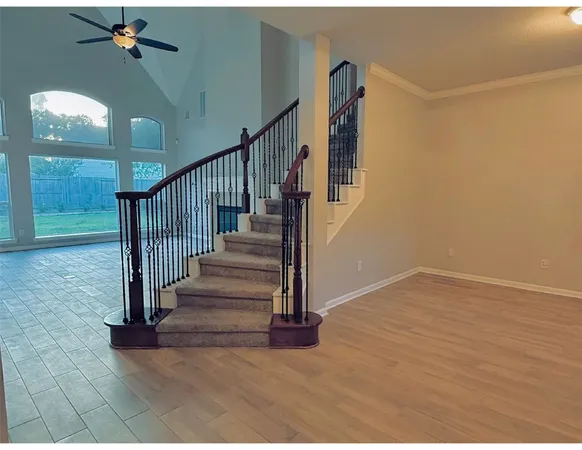 a view of entryway and hall with wooden floor