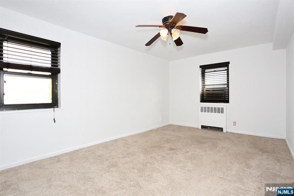 208 Anderson Street, Unit S4F Hackensack, NJ 07601 - Photo 9 of 18 a view of a ceiling fan and a window