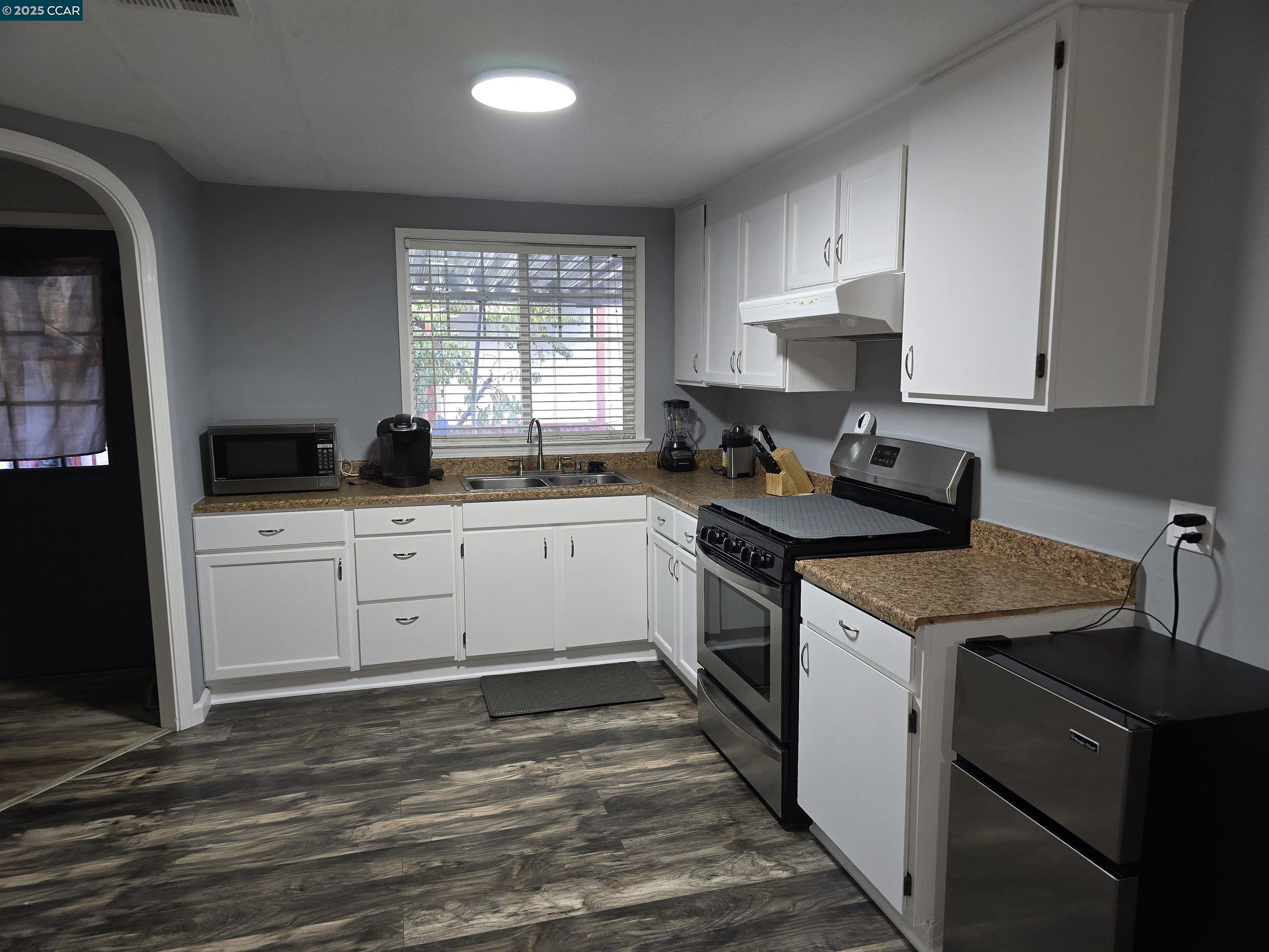 16711 Marsh Creek Road, Unit 112 Clayton, CA 94517 - Photo 16 of 30 a kitchen with a stove sink and cabinets