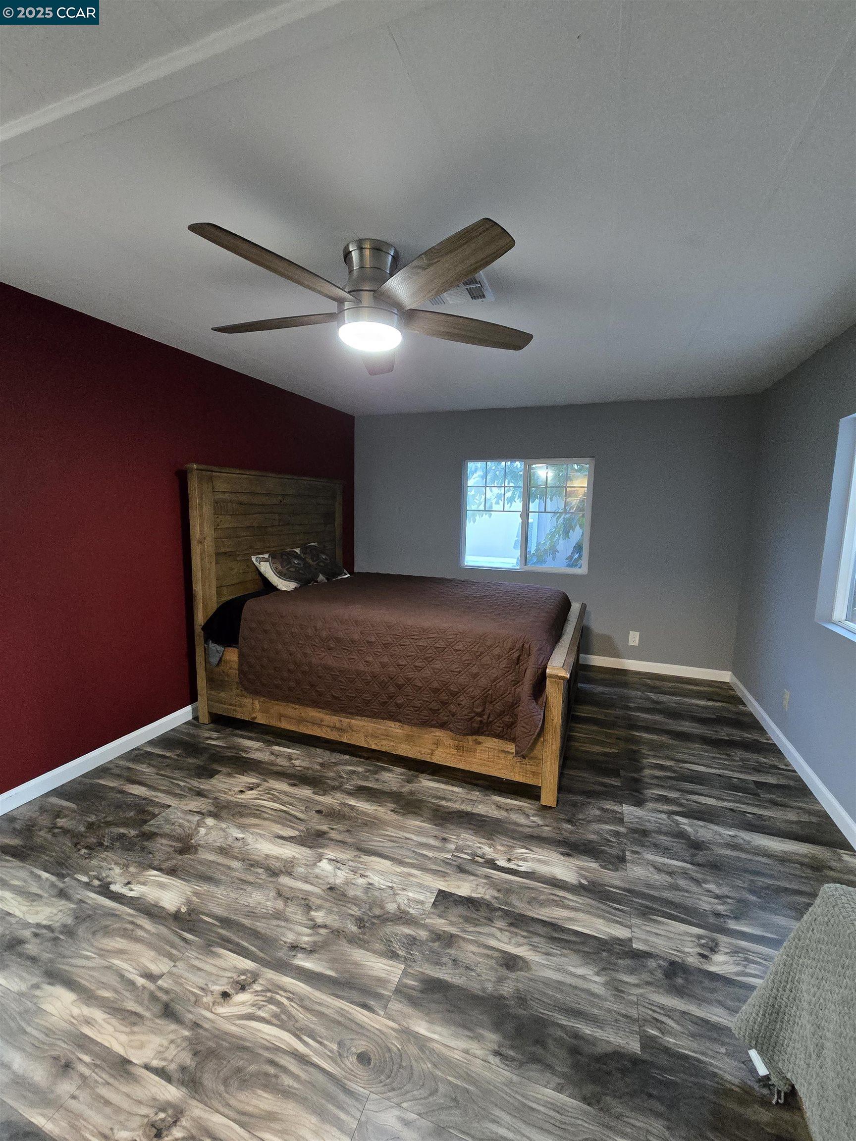 16711 Marsh Creek Road, Unit 112 Clayton, CA 94517 - Photo 27 of 30 a spacious bedroom with a large bed and a chandelier