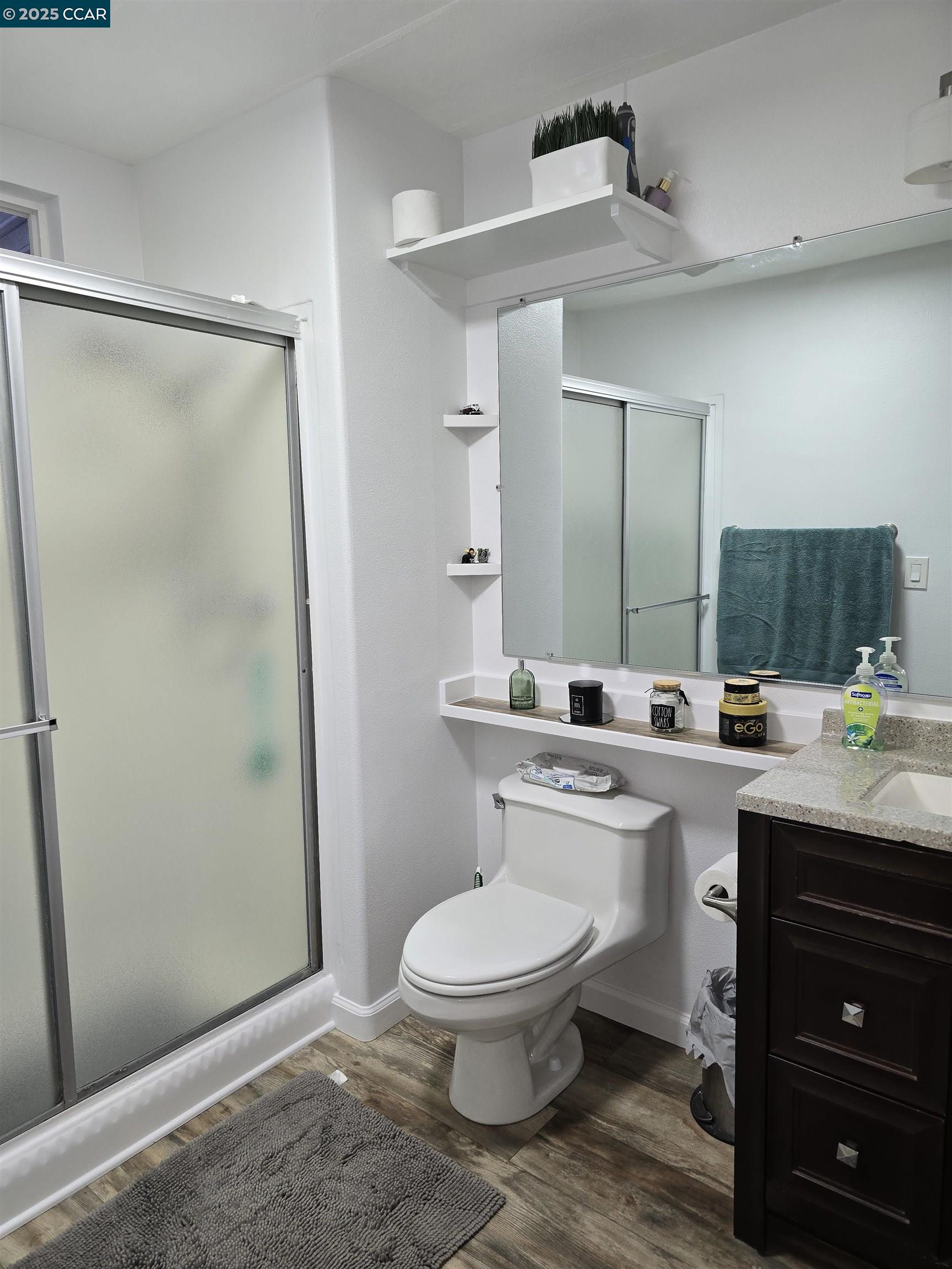16711 Marsh Creek Road, Unit 112 Clayton, CA 94517 - Photo 28 of 30 a bathroom with a toilet a sink and mirror