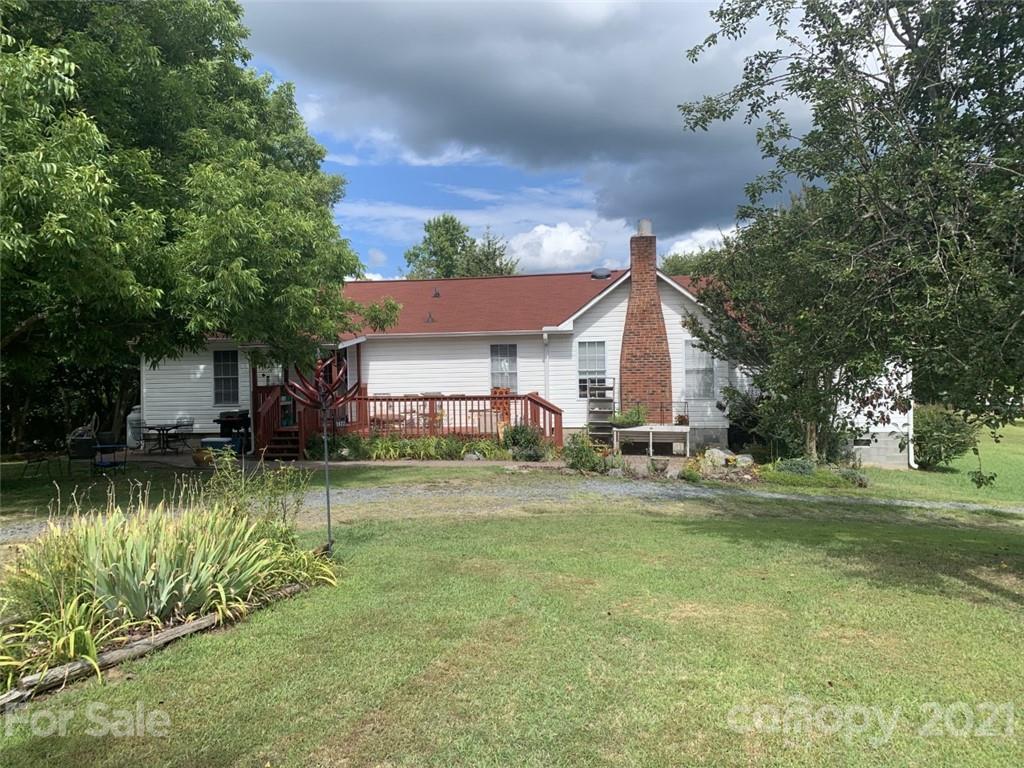 1822 Sharon Road York, SC 29745 - Photo 1 of 39 a front view of a house with a yard table and chairs