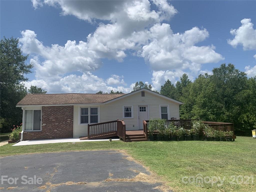 1822 Sharon Road York, SC 29745 - Photo 20 of 39 a front view of a house with a garden and garage
