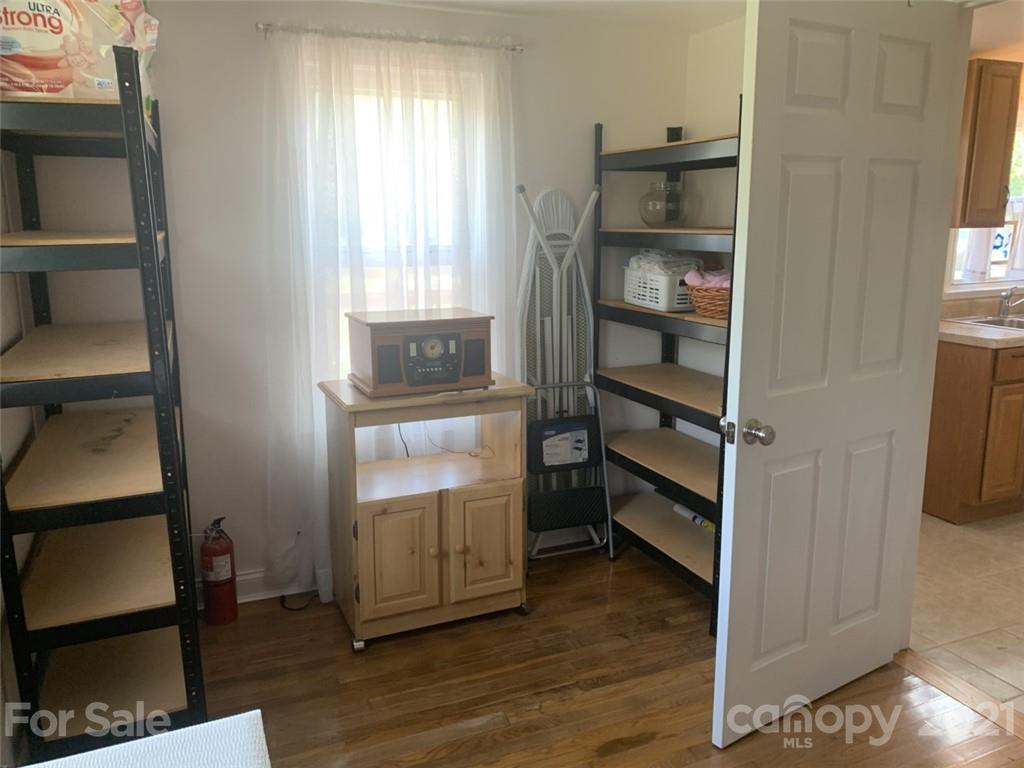 1822 Sharon Road York, SC 29745 - Photo 32 of 39 a view of an empty room with wooden floor and a window