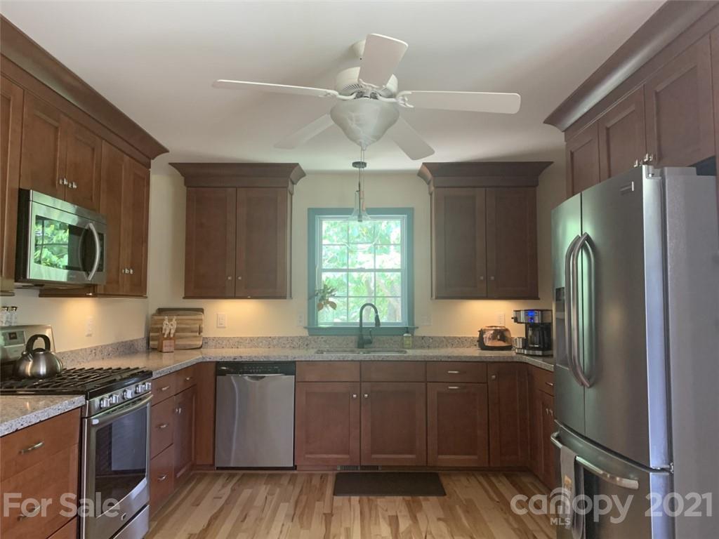 1822 Sharon Road York, SC 29745 - Photo 5 of 39 a kitchen with granite countertop a sink cabinets stainless steel appliances and a window