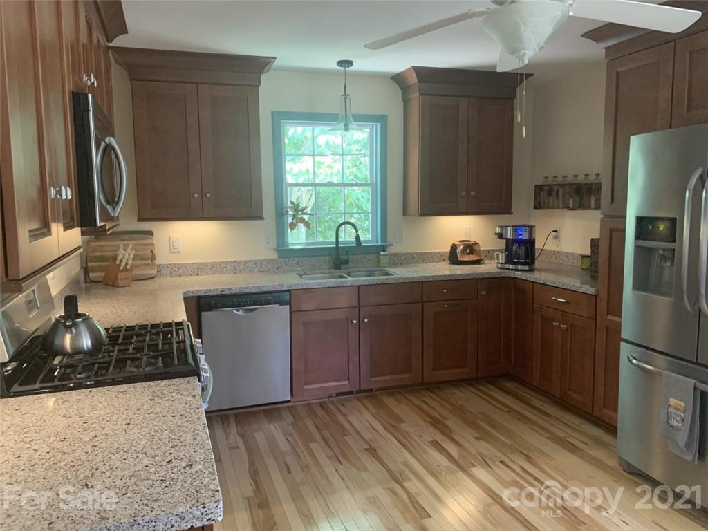 1822 Sharon Road York, SC 29745 - Photo 6 of 39 a kitchen with stainless steel appliances granite countertop a sink stove and refrigerator