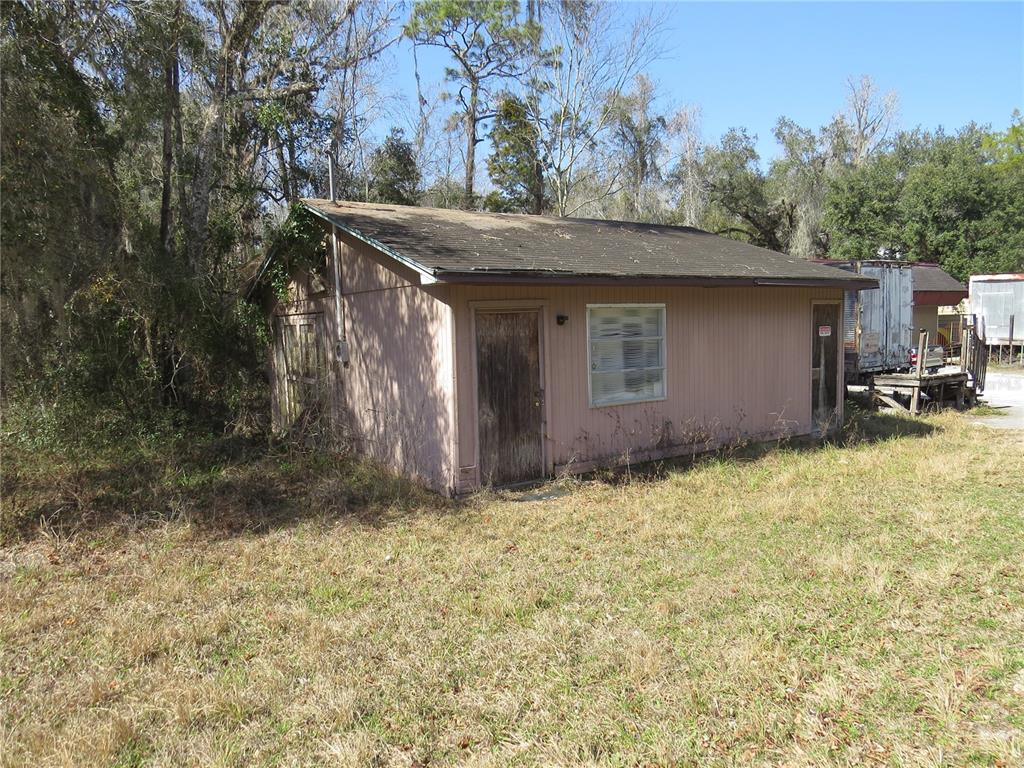 28380 Forbes Street Nobleton, FL 34661 - Photo 11 of 19 a backyard of a house with yard and garage