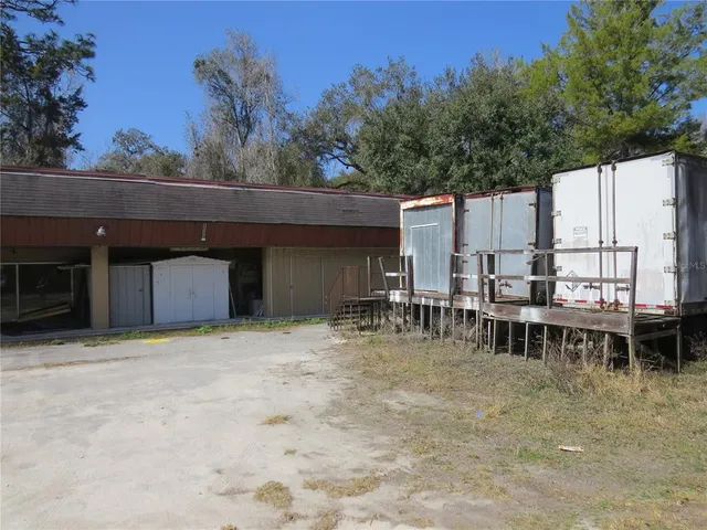 a view of a house with backyard and sitting area