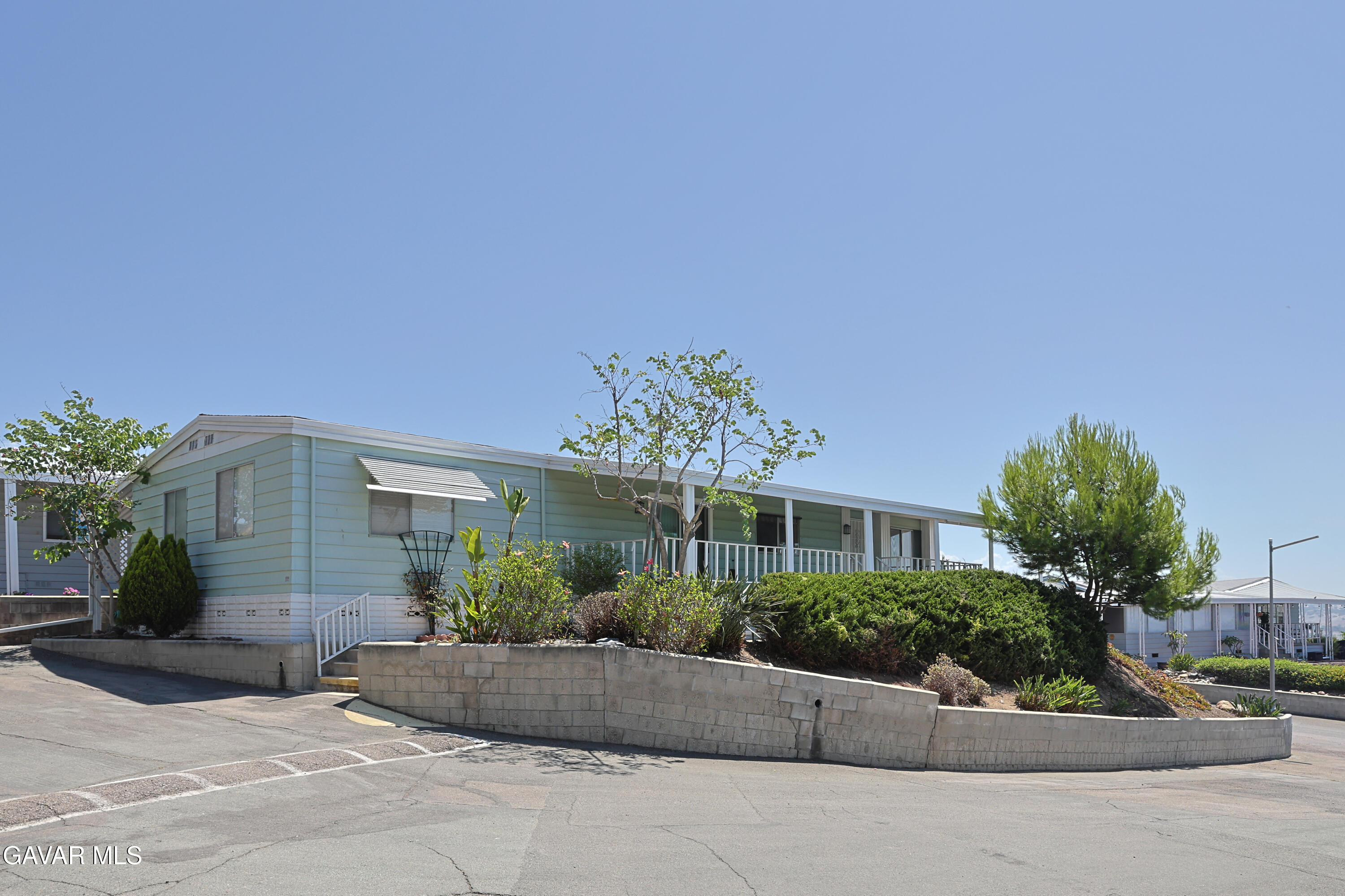 275 South Worthington Street Spring Valley, CA 91977 - Photo 2 of 30 a front view of a house with garage and plants