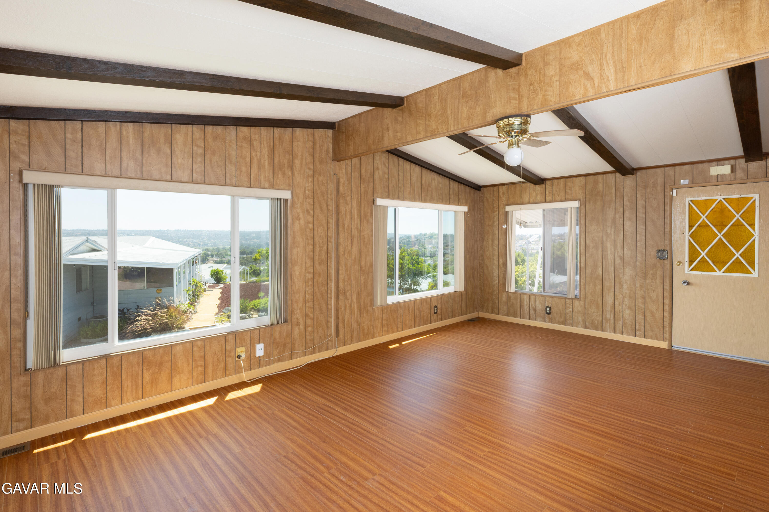 275 South Worthington Street Spring Valley, CA 91977 - Photo 5 of 30 a view of an empty room with wooden floor and a window
