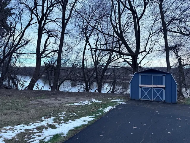 a view of a backyard with large trees