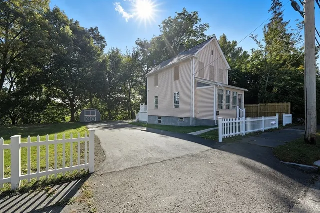 a view of a small house with backyard