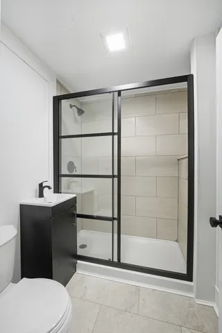 a bathroom with a toilet a sink and shower