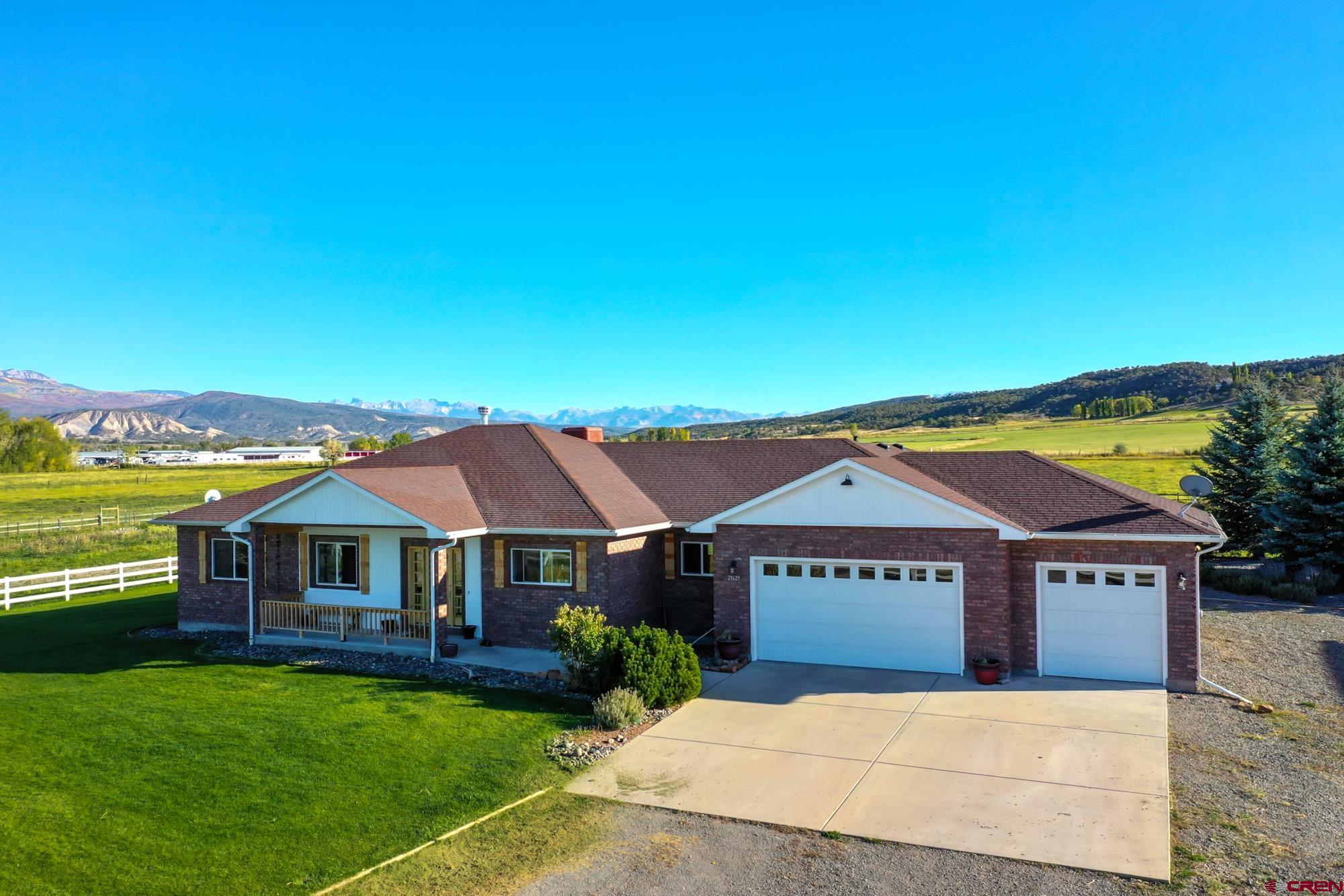 a front view of house with yard and outdoor seating