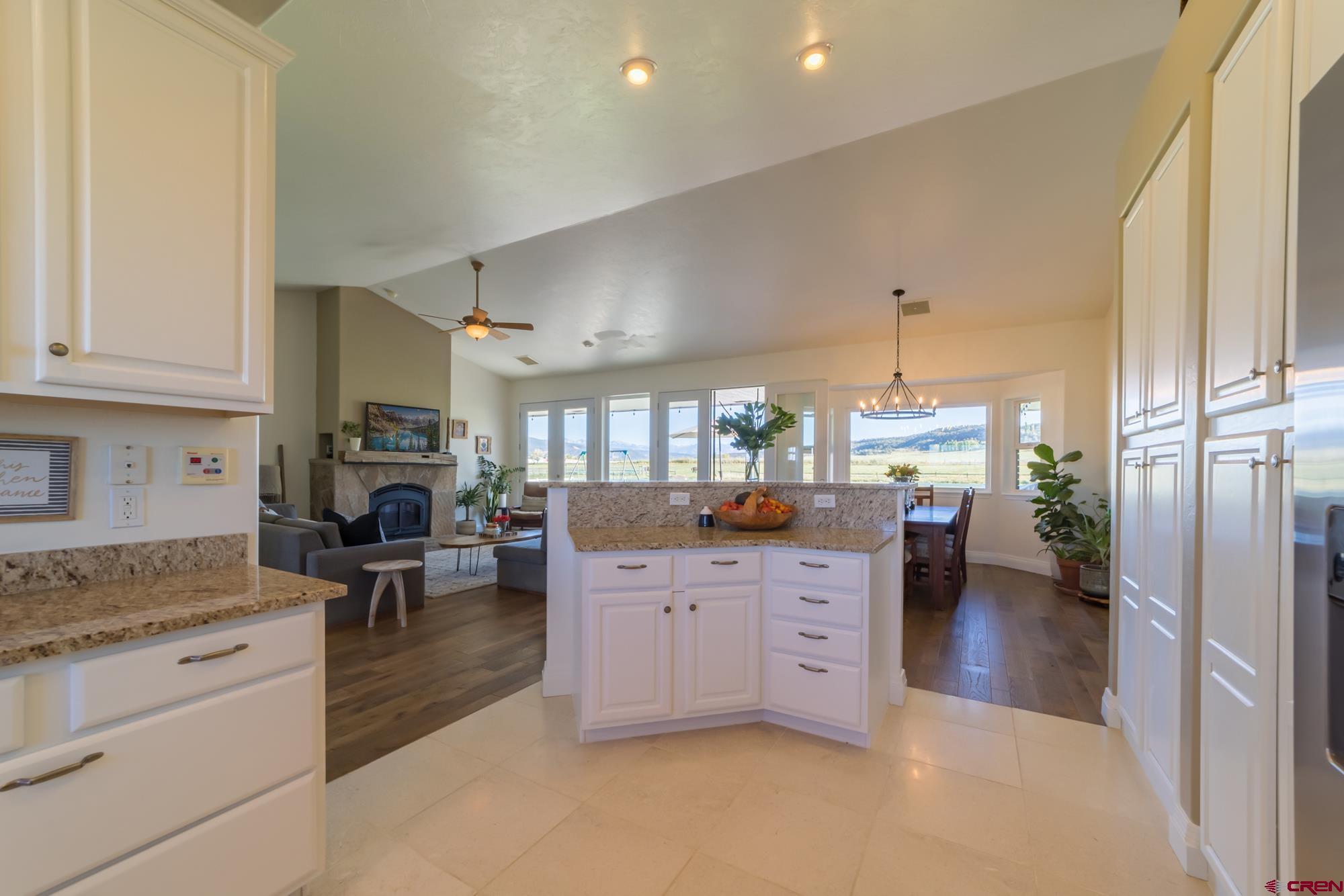 68041 Ute Vly Drive Montrose, CO 81403 - Photo 12 of 35 a kitchen with granite countertop a stove a sink and a refrigerator