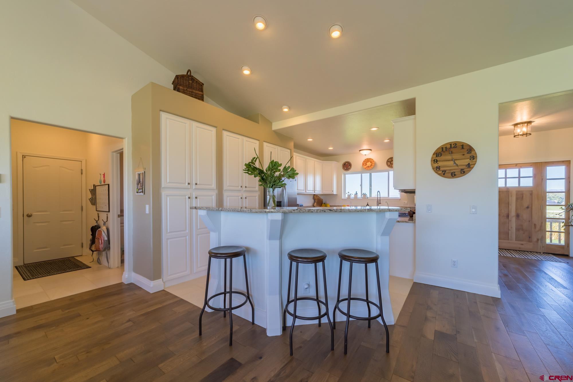 68041 Ute Vly Drive Montrose, CO 81403 - Photo 13 of 35 a kitchen with stainless steel appliances kitchen island granite countertop a table chairs and a refrigerator