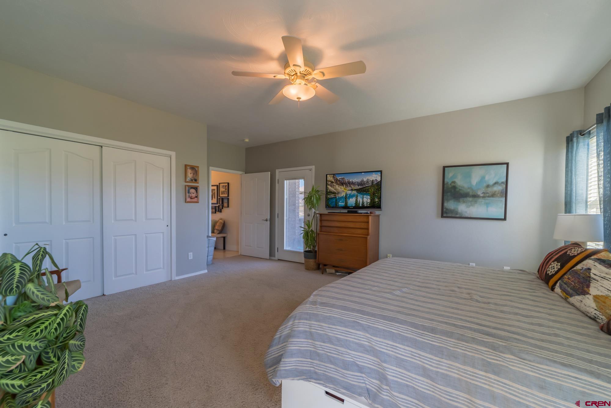 68041 Ute Vly Drive Montrose, CO 81403 - Photo 16 of 35 a bedroom with a bed and a chandelier