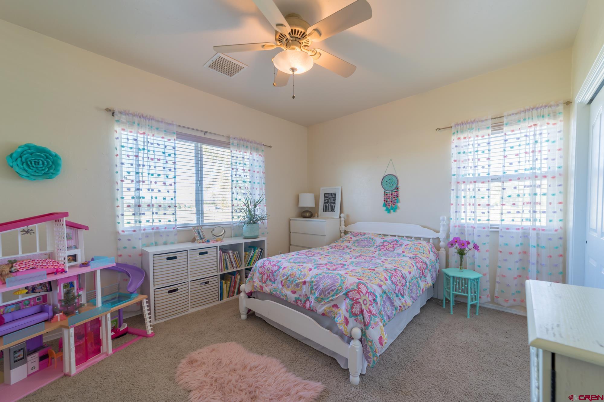 68041 Ute Vly Drive Montrose, CO 81403 - Photo 20 of 35 a bedroom with a bed closet and a window