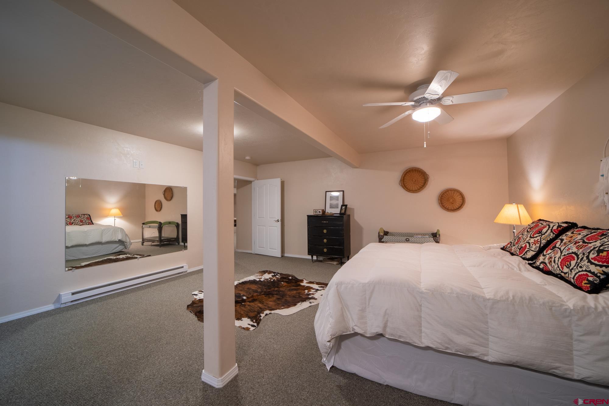 68041 Ute Vly Drive Montrose, CO 81403 - Photo 25 of 35 a bedroom with a bed and a flat screen tv