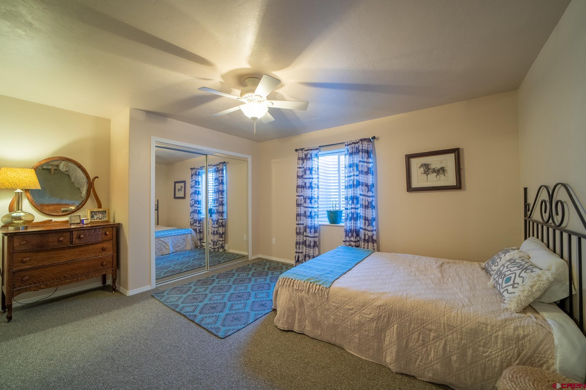 68041 Ute Vly Drive Montrose, CO 81403 - Photo 28 of 35 a bedroom with a bed and cabinets