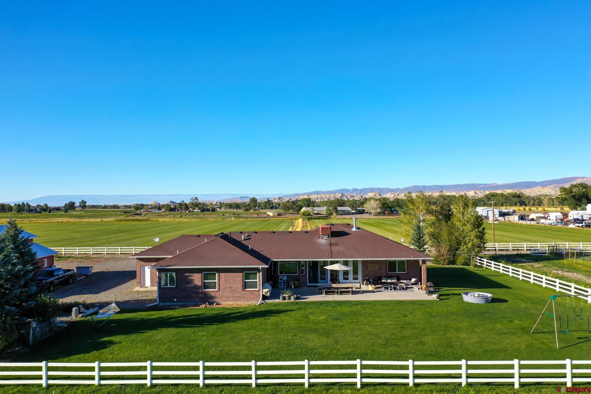 68041 Ute Vly Drive Montrose, CO 81403 - Photo 32 of 35 a view of a patio with a table and chairs under an umbrella