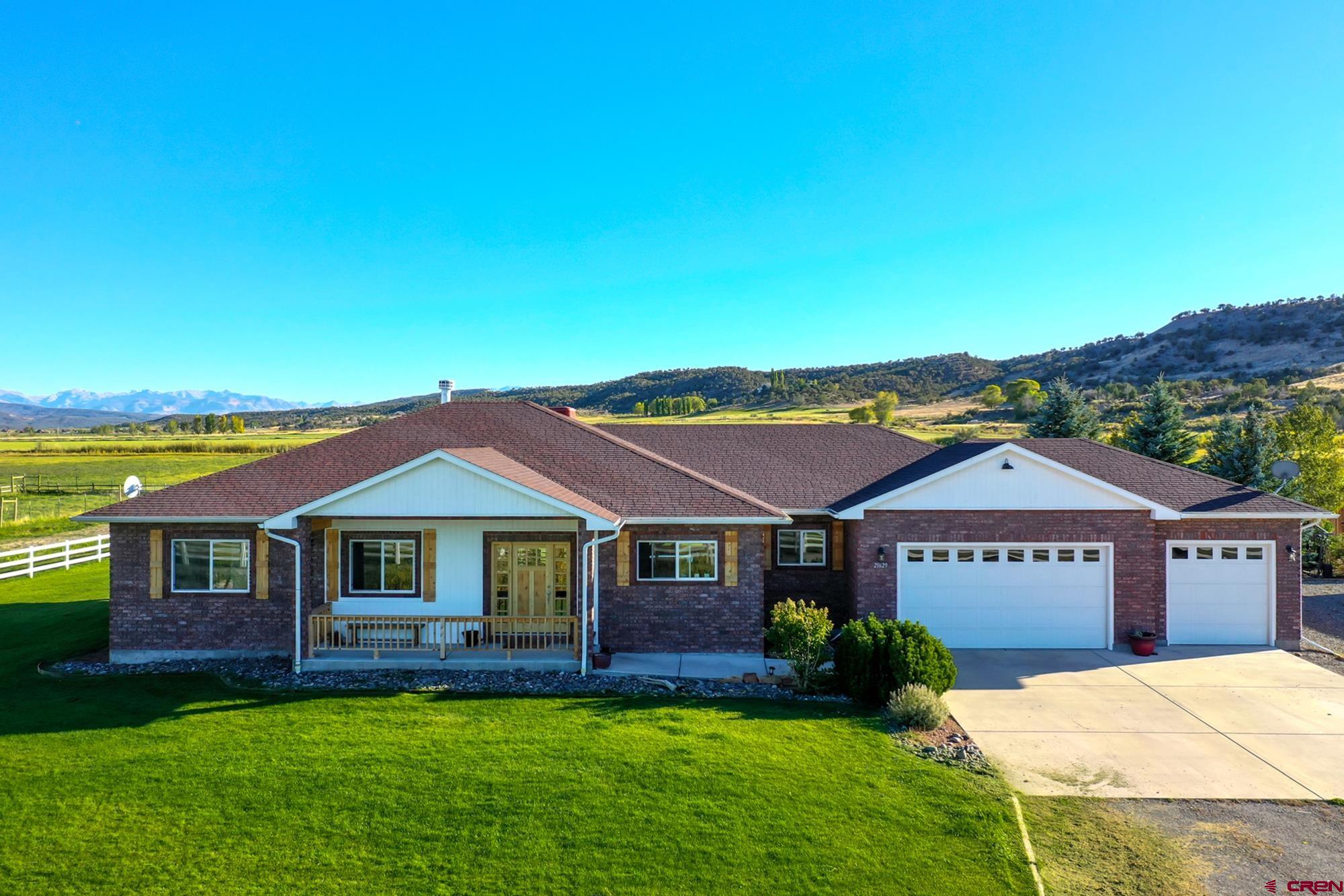 68041 Ute Vly Drive Montrose, CO 81403 - Photo 35 of 35 a view of a house with a big yard and potted plants