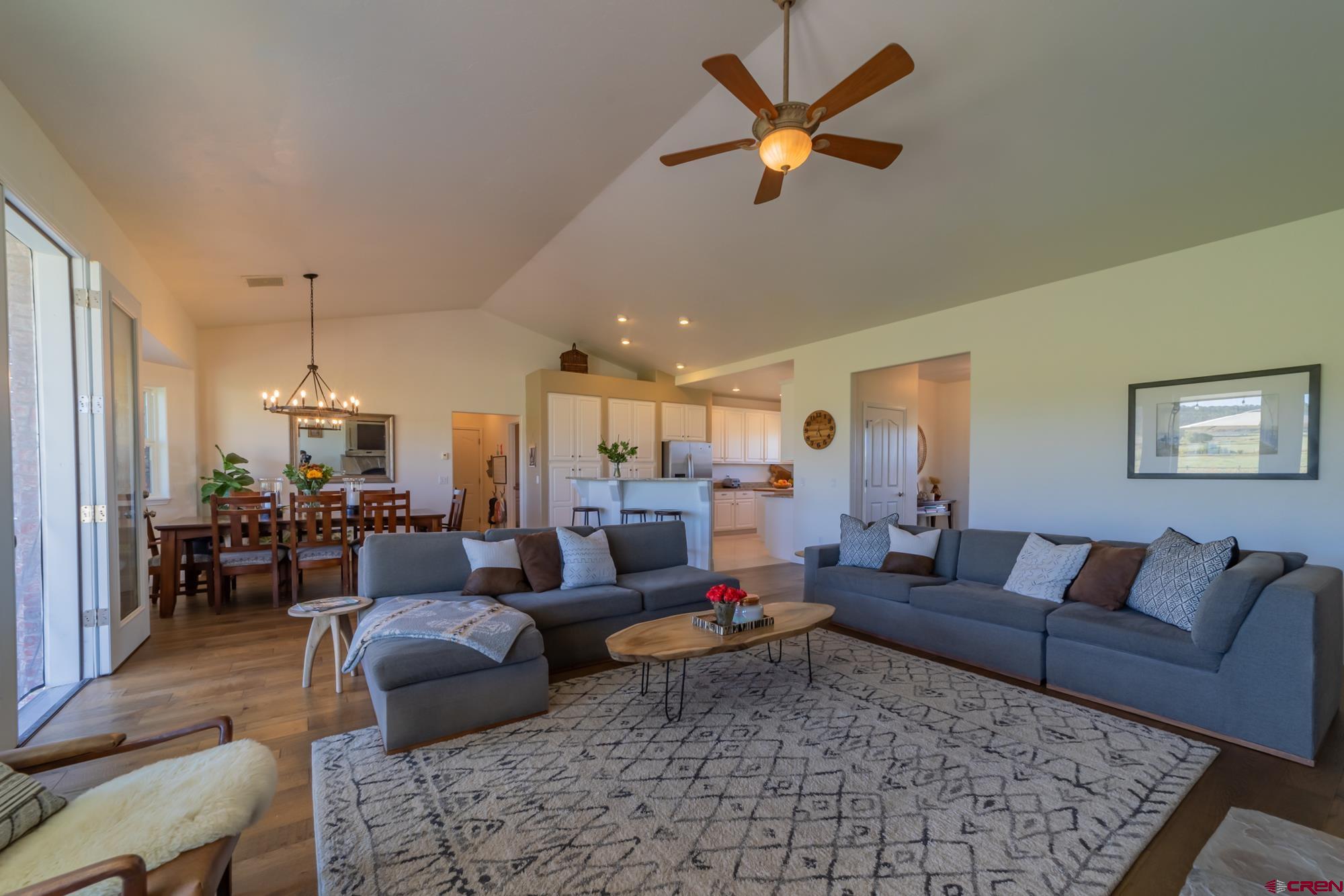 68041 Ute Vly Drive Montrose, CO 81403 - Photo 8 of 35 a living room with furniture and a chandelier