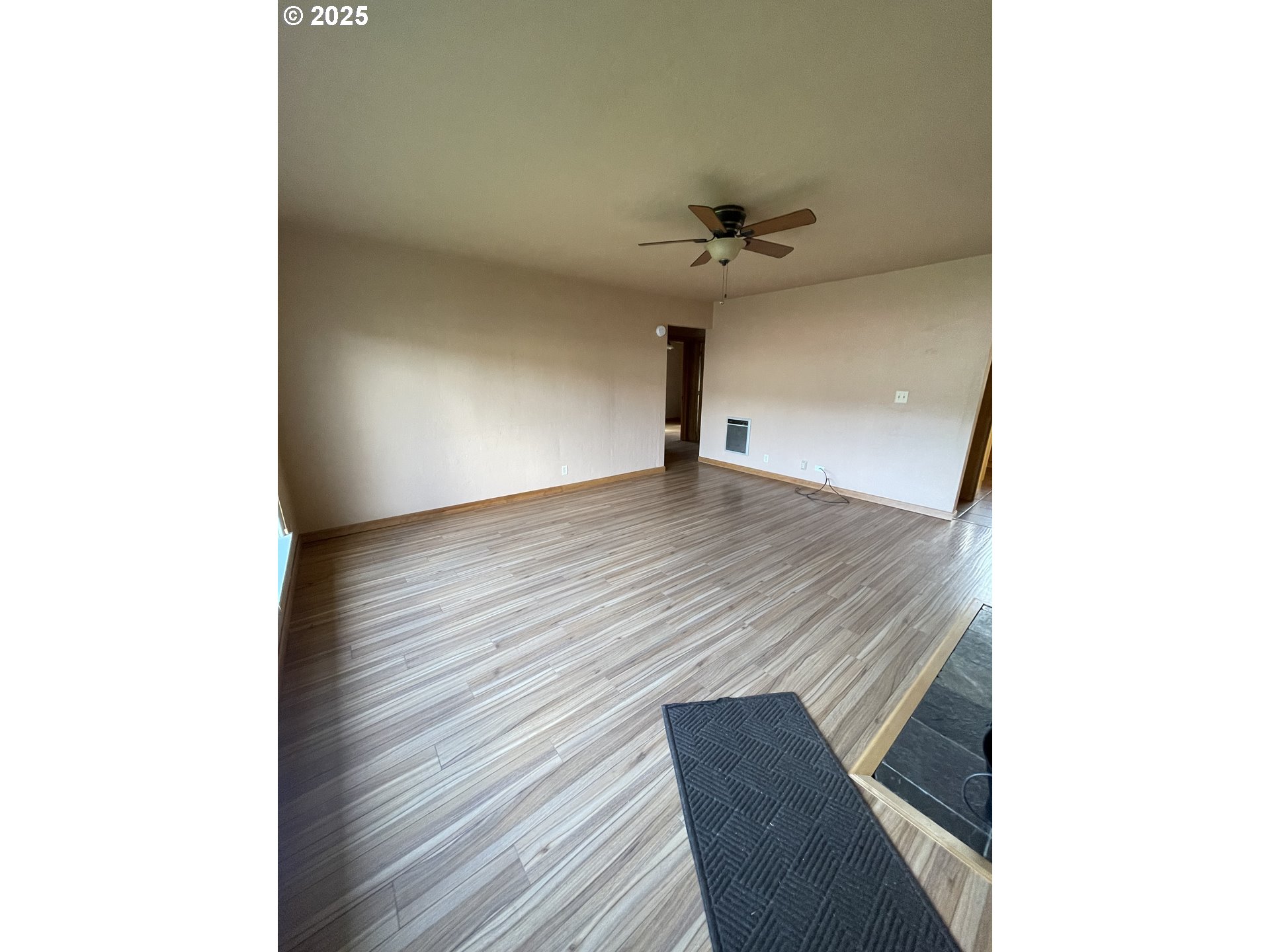 1820 Dogwood Avenue Reedsport, OR 97467 - Photo 2 of 29 a view of an empty room with a ceiling fan and wooden floor