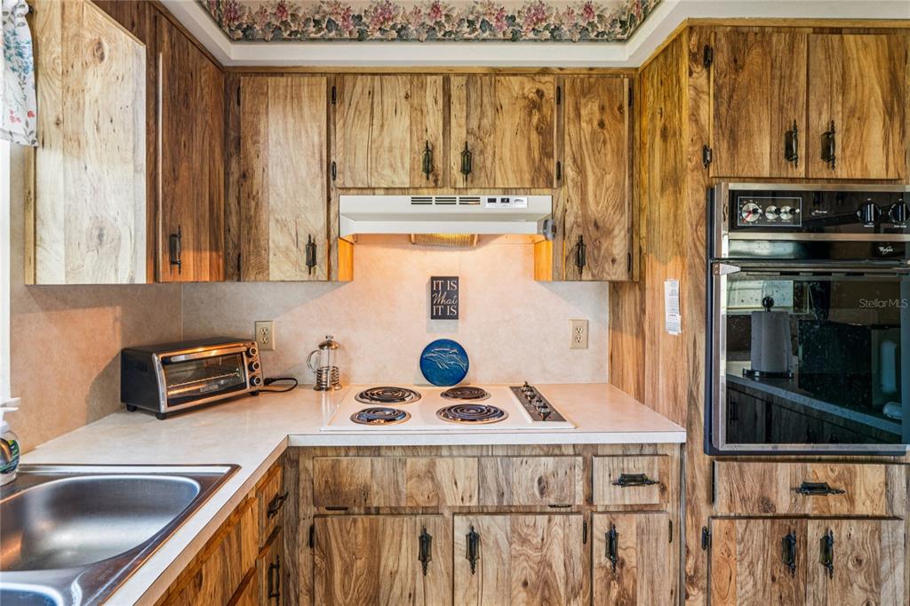 6709 Timbercove Lane, Unit 6709 New Port Richey, FL 34653 - Photo 13 of 52 a kitchen with a stove a sink and a refrigerator